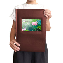 Load image into Gallery viewer, Woman holding leather album to show scale.
